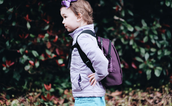 A profile shot of a child wearing The Sprout.